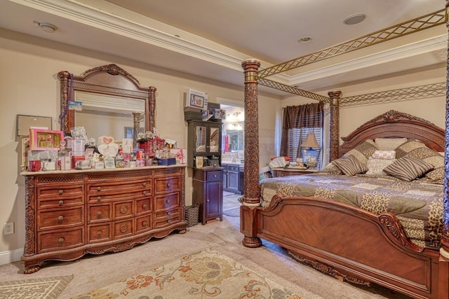 carpeted bedroom featuring crown molding and ensuite bathroom