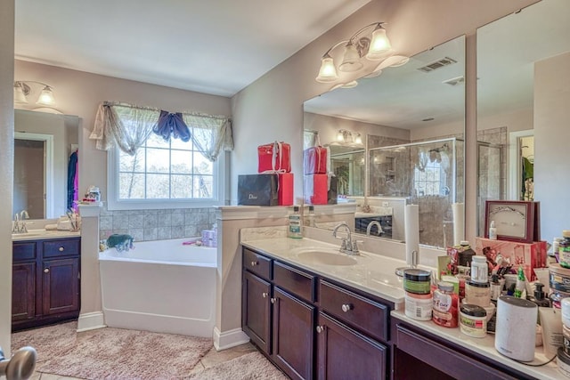 bathroom featuring tile patterned flooring, vanity, and plus walk in shower