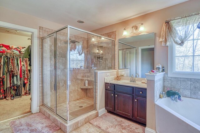 bathroom with vanity and independent shower and bath