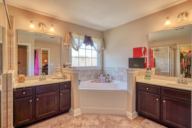 bathroom featuring vanity and shower with separate bathtub