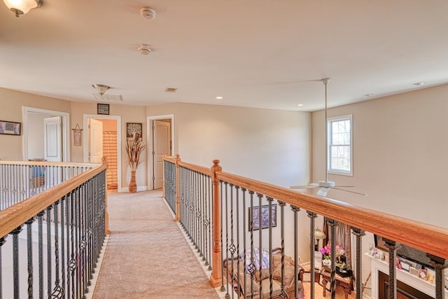 corridor featuring light colored carpet