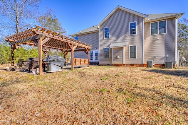 rear view of property featuring a pergola, central air condition unit, and a lawn