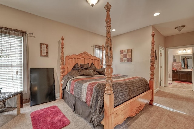 carpeted bedroom featuring ensuite bathroom