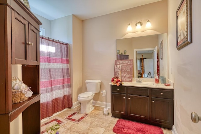 bathroom featuring tile patterned floors, vanity, and toilet