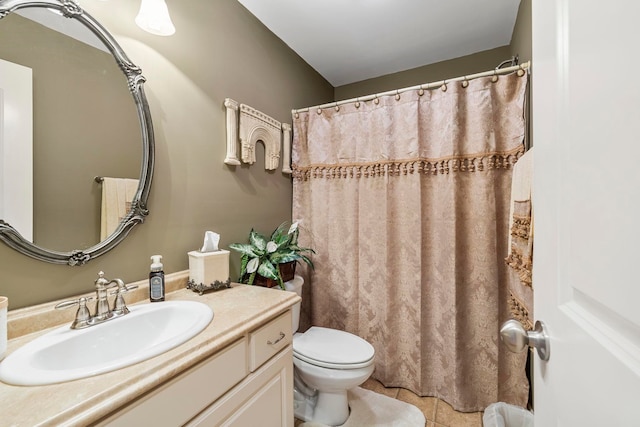 bathroom with tile patterned flooring, vanity, and toilet