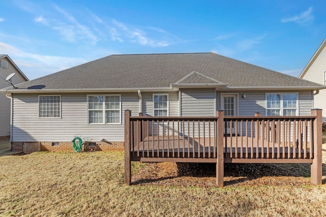 back of property featuring a lawn and a deck