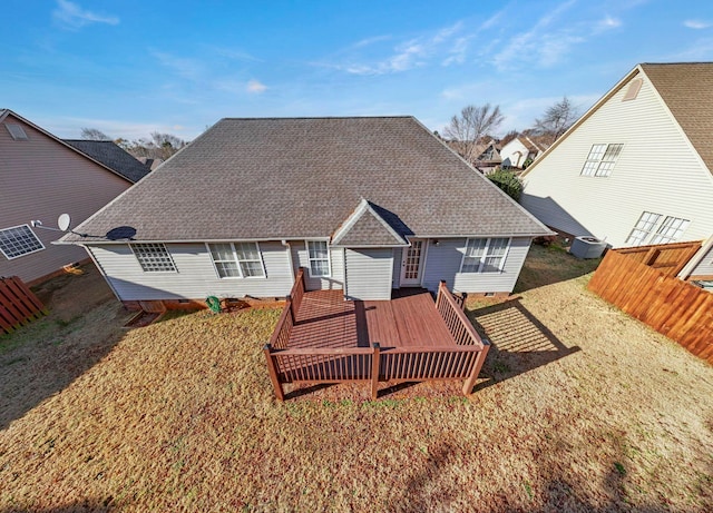 rear view of property featuring a yard and a wooden deck