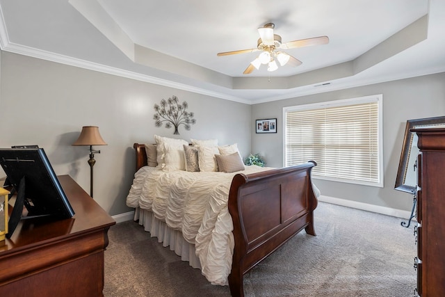 carpeted bedroom featuring ceiling fan, crown molding, and a tray ceiling