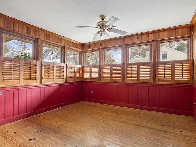 unfurnished sunroom featuring ceiling fan