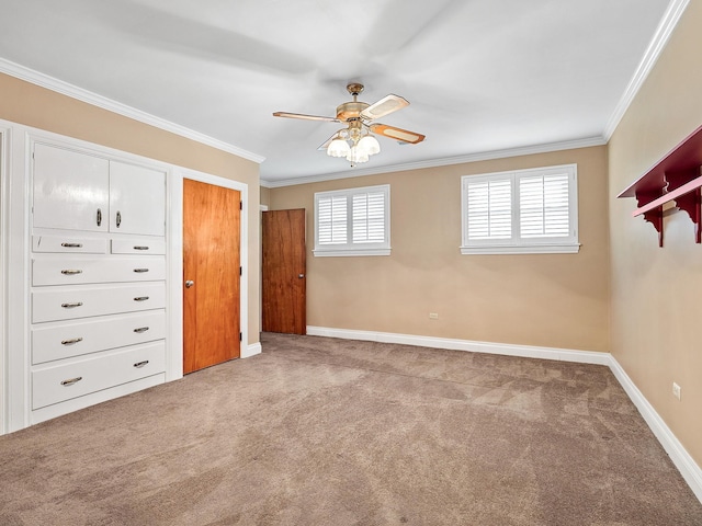 unfurnished bedroom featuring carpet, ceiling fan, and crown molding