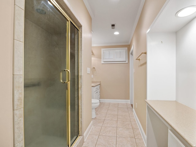 bathroom featuring vanity, a shower with door, crown molding, tile patterned flooring, and toilet