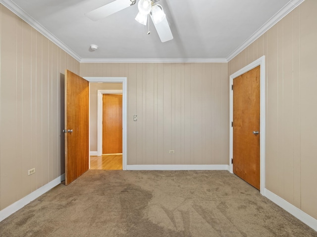 spare room featuring carpet flooring, ceiling fan, and crown molding