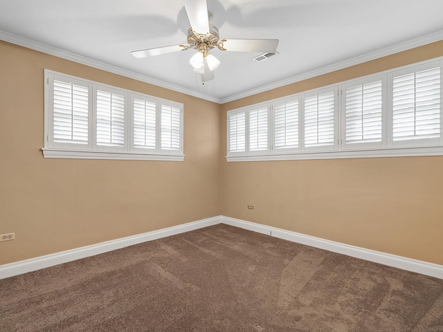 empty room featuring crown molding, carpet floors, and ceiling fan