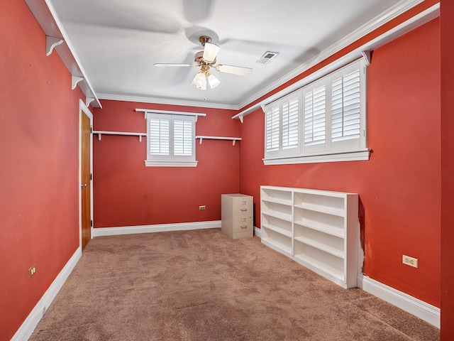 unfurnished bedroom featuring ceiling fan, carpet floors, and crown molding