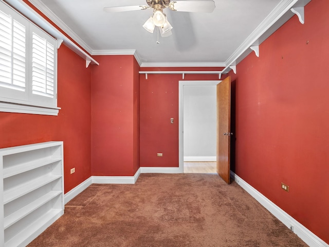 carpeted empty room featuring ceiling fan and ornamental molding