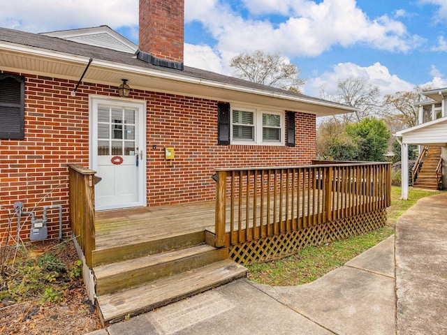 view of exterior entry featuring a deck