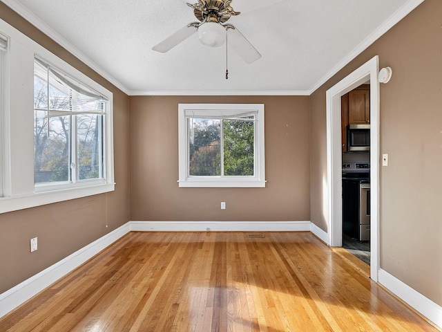 unfurnished room with a textured ceiling, light hardwood / wood-style floors, ceiling fan, and ornamental molding