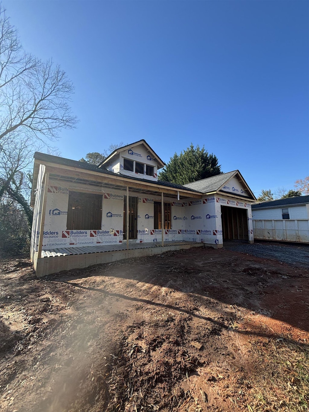 property under construction with a porch and a garage