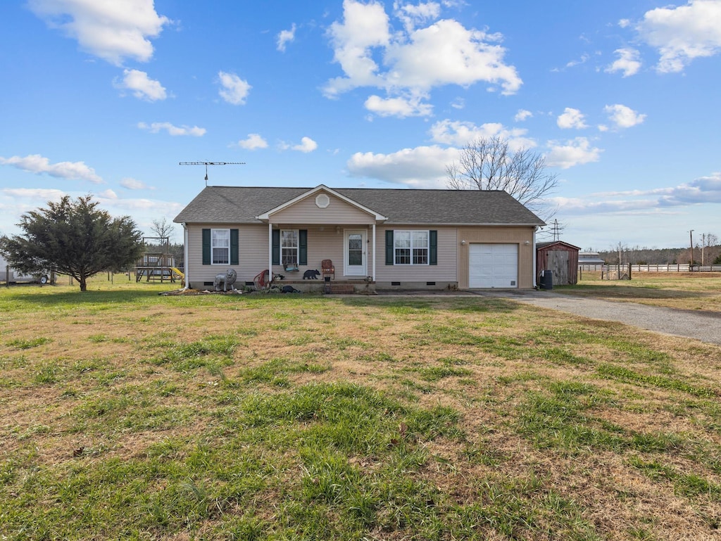 ranch-style house with an outbuilding, a porch, and a front yard