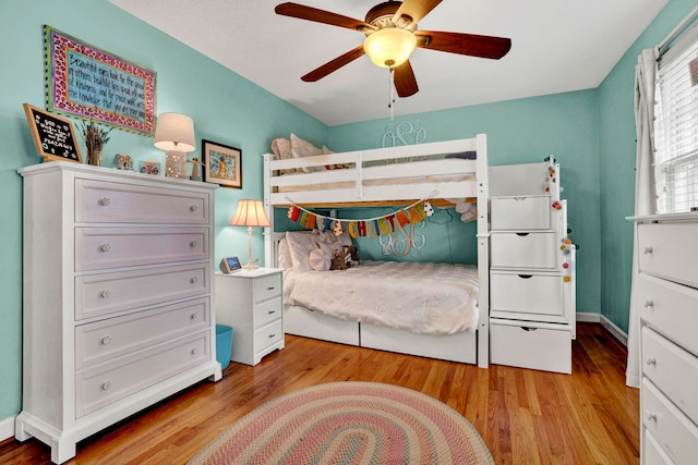 bedroom with ceiling fan and light hardwood / wood-style floors