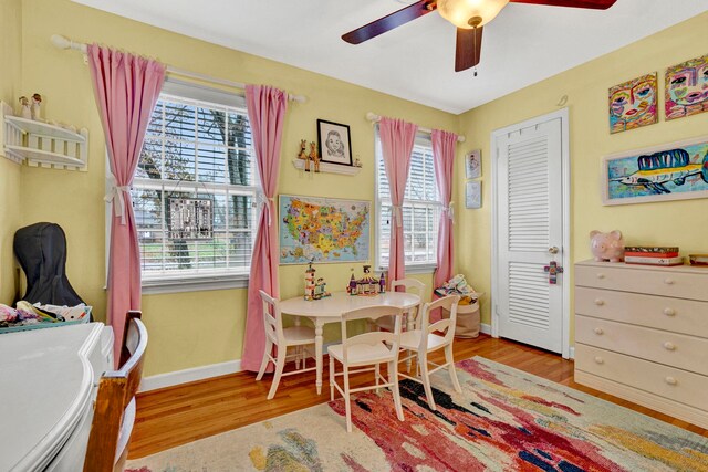 rec room with ceiling fan and light hardwood / wood-style flooring