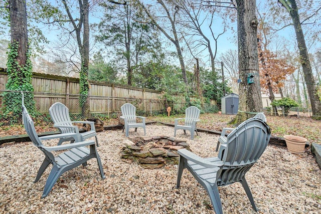 view of yard with a shed and an outdoor fire pit