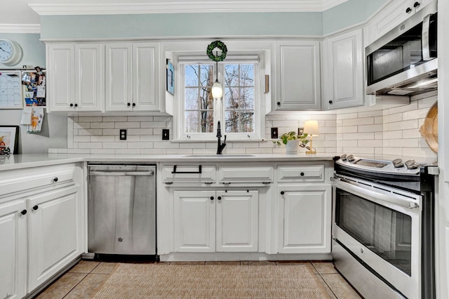 kitchen featuring appliances with stainless steel finishes, white cabinetry, and light tile patterned flooring