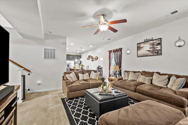 carpeted living room featuring ceiling fan