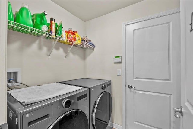 washroom featuring washing machine and dryer