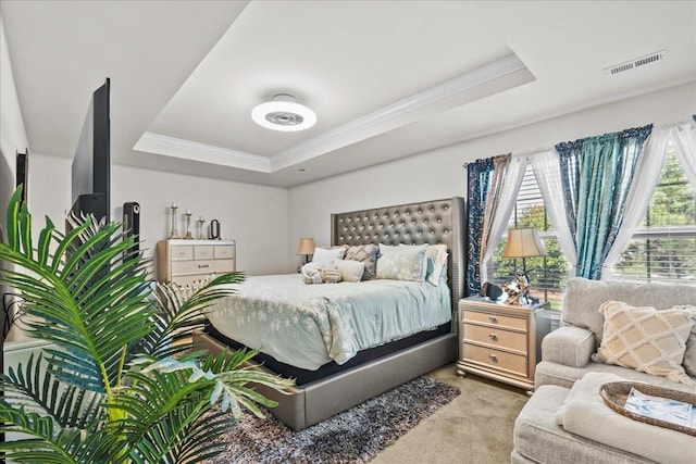 bedroom with light carpet, a raised ceiling, and ornamental molding