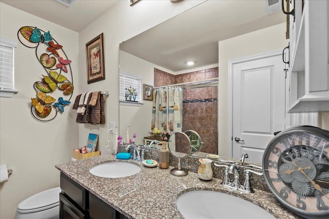 bathroom featuring vanity, toilet, and walk in shower