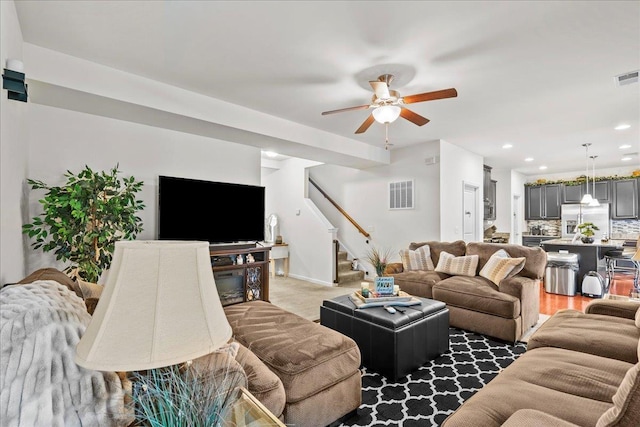 living room with ceiling fan and dark hardwood / wood-style floors