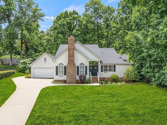 view of front of property with a front yard and a garage