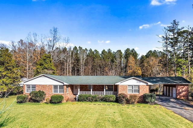 ranch-style home featuring a front lawn, a porch, and a carport