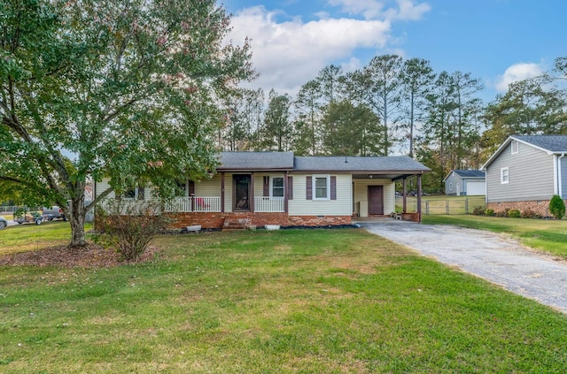 ranch-style home with a carport, a porch, and a front lawn