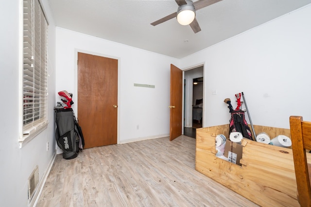 interior space with ceiling fan and wood-type flooring