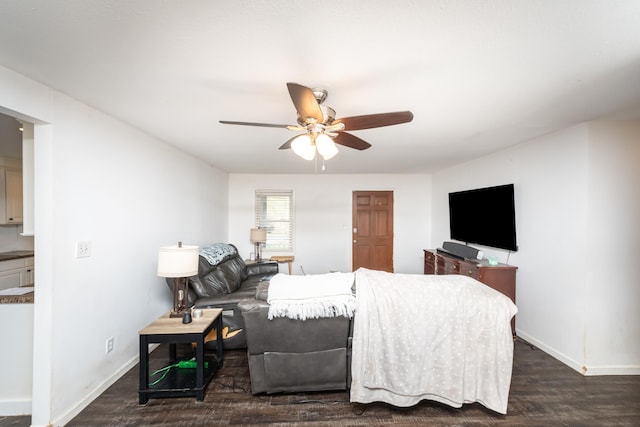 living room with ceiling fan and dark wood-type flooring