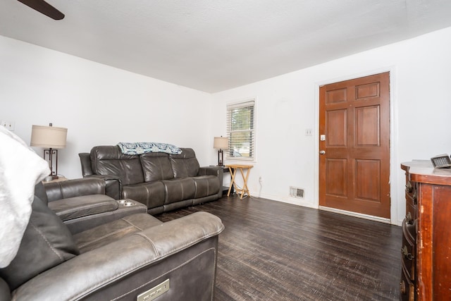 living room featuring a textured ceiling and dark hardwood / wood-style flooring