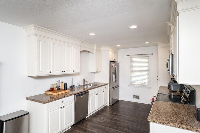 kitchen featuring white cabinetry, sink, dark wood-type flooring, and appliances with stainless steel finishes