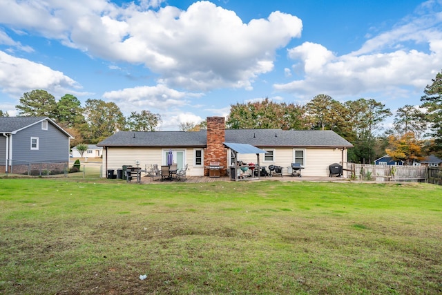 rear view of property with a yard and a patio