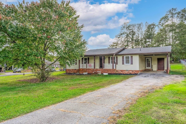 ranch-style house with a porch and a front lawn