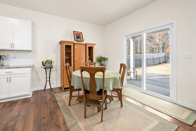 dining space featuring dark wood-type flooring