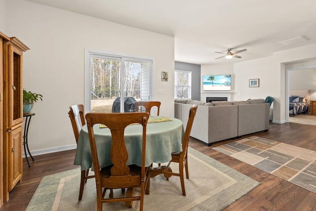 dining area featuring ceiling fan and dark wood-type flooring