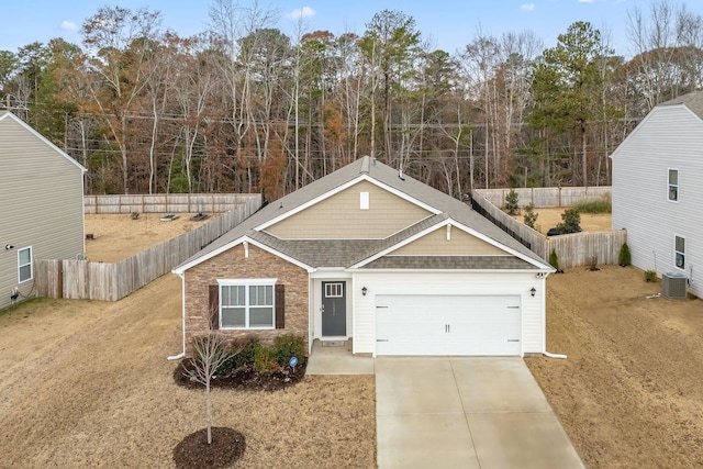 view of front of house with a garage and central AC unit