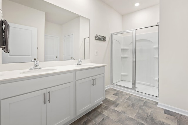 bathroom with vanity and a shower with shower door