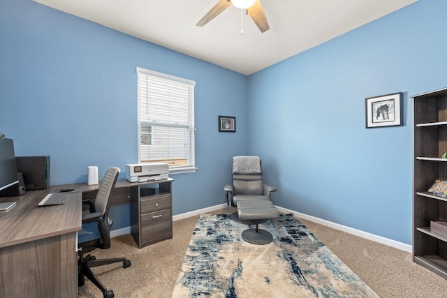 carpeted home office featuring ceiling fan