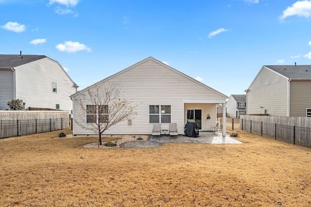 back of property featuring a patio area and a yard