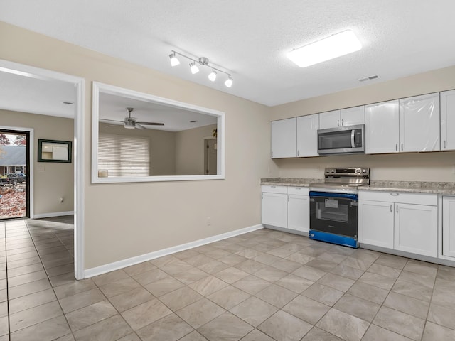 kitchen with white cabinets, stainless steel appliances, plenty of natural light, and ceiling fan