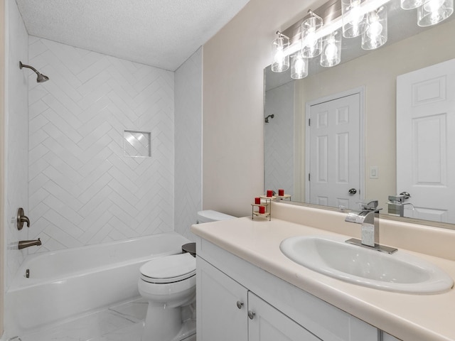 full bathroom featuring toilet, vanity, a textured ceiling, and tiled shower / bath