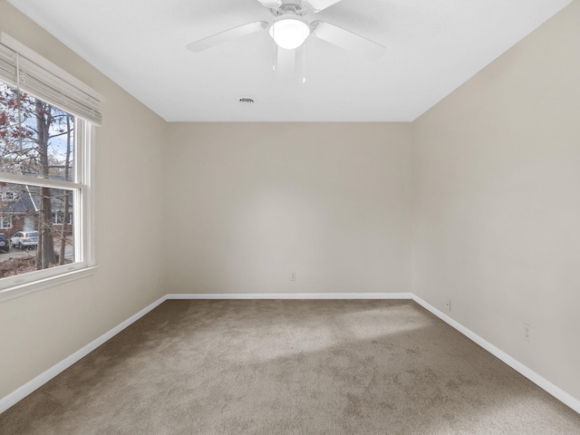 carpeted spare room with ceiling fan